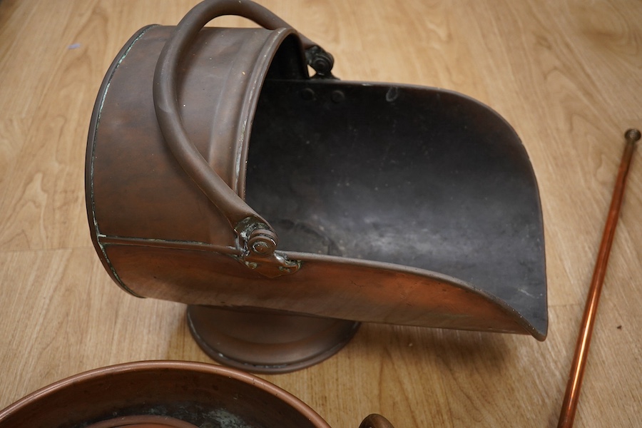 Victorian copper, including a two handled preserve pan, a copper hunting horn, a helmet coal scuttle and a warming pan. Scuttle 32cm high. Condition - hunting horn dented